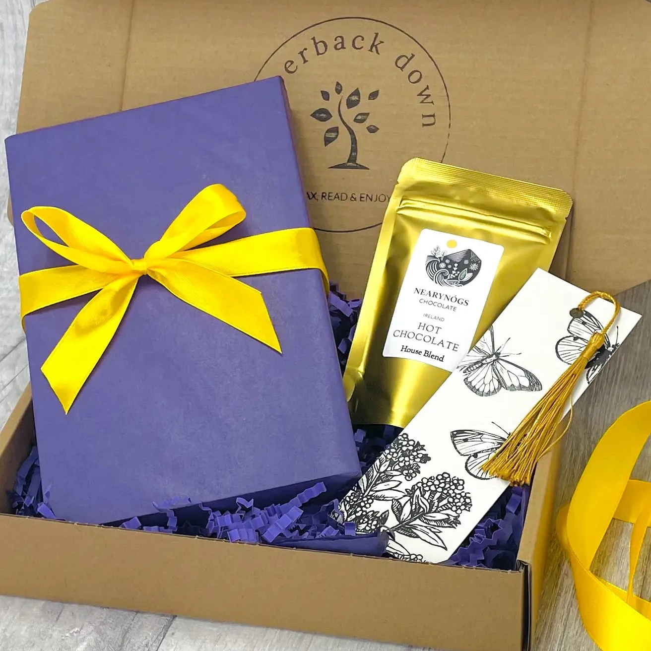 Blind Date With A Book Gift Box, contacting a new book, beautifully wrapped, a mini-pouch of drinking chocolate and a tassel bookmark.