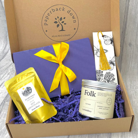 Gift box for booklovers by Paperback Down with a new books, candle, and bookmark
