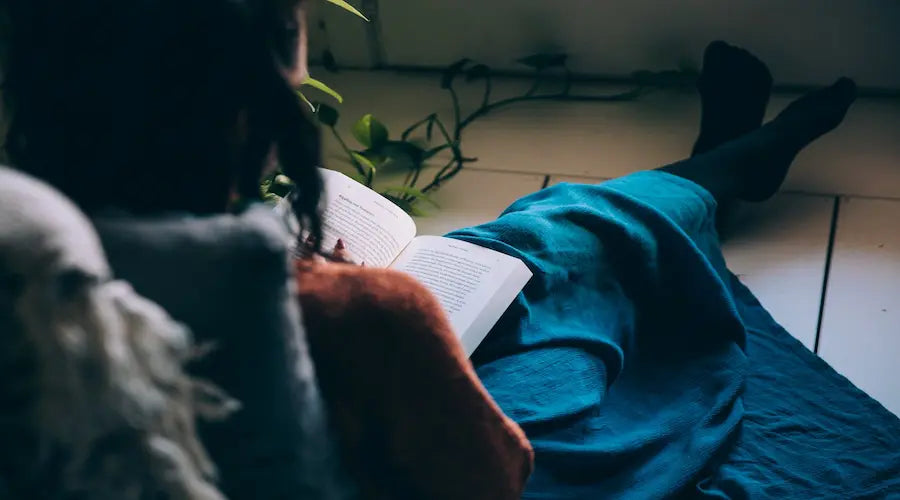 Cosy image of a woman relaxing with a new book