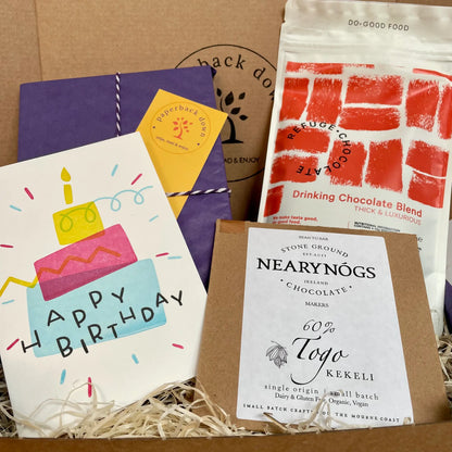 A birthday gift box for booklovers featuring a new book from your chosen genre, along with hot chocolate from Refuge Chocolate, a delicious bar of NearyNogs chocolate and a birthday card - all made locally in Northern Ireland.