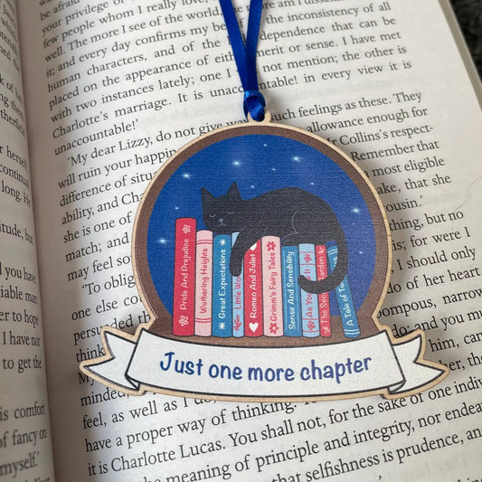 Book-themed decorative item with a cat and books design on an open book