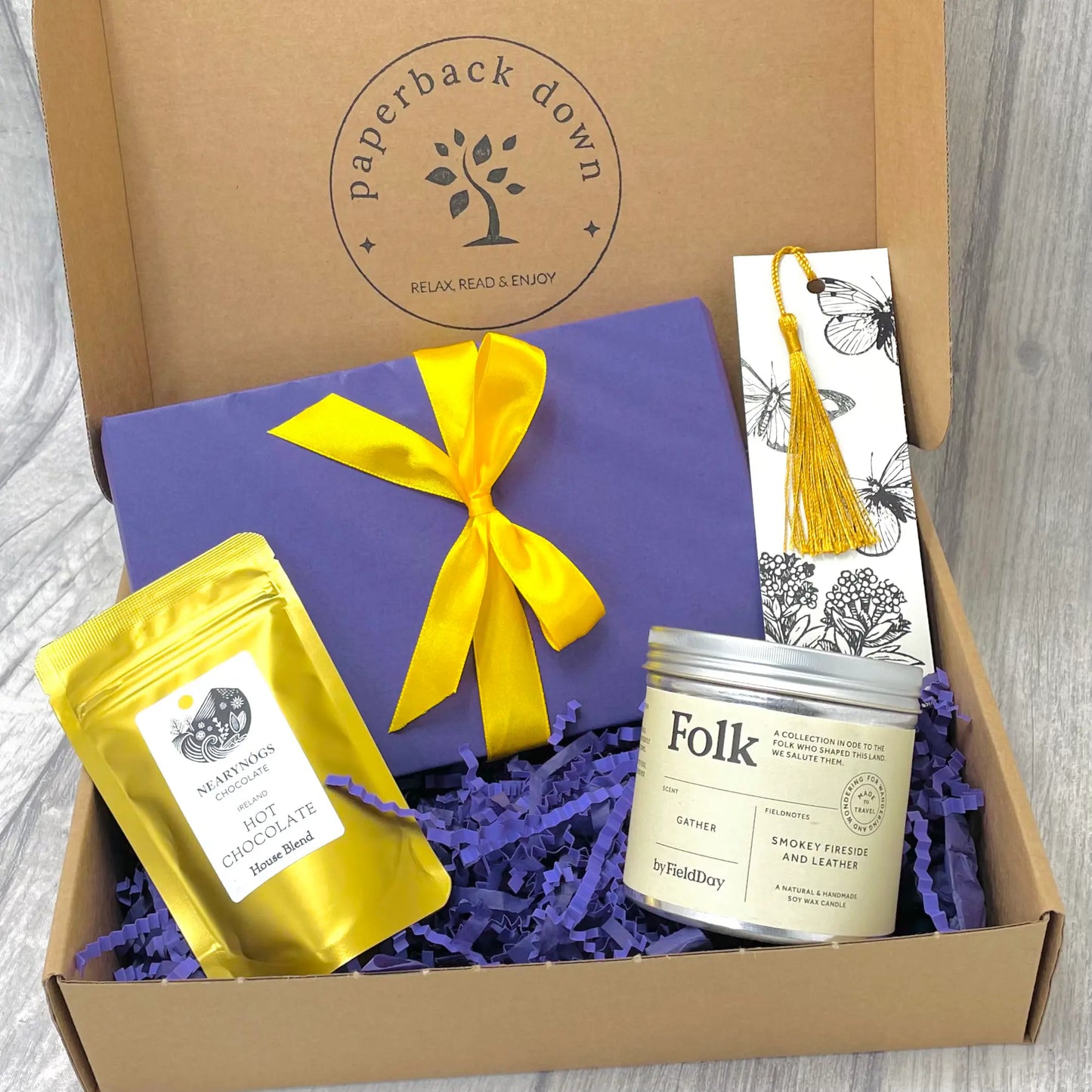 Gift box for booklovers by Paperback Down with a new books, candle, and bookmark