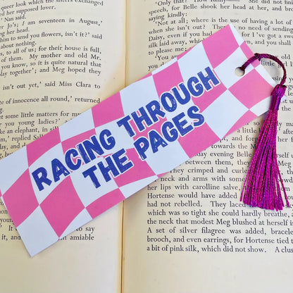 Images shows a bookmark with the words 'Racing Through The Pages' against a pink and white chequered flag inspired background