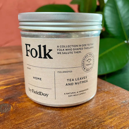 A candle in a tin, made by County Down artisan candle-makers, Field Day. The candle shown is from their Folk range and the scent is Home - a soothing and relaxing aroma with notes of Tea Leaves and Nutmeg 