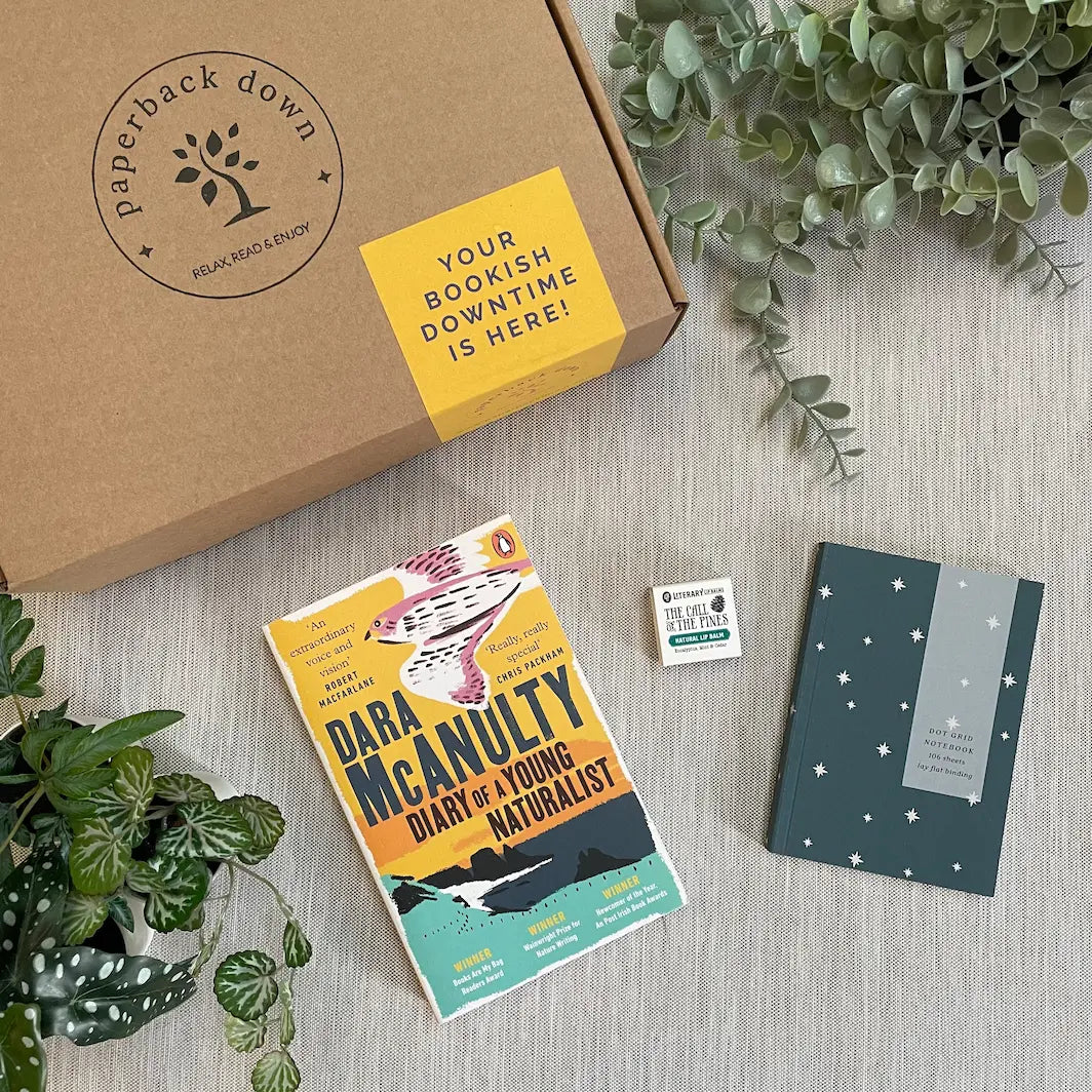 A picture of a paperback book - Diary of A Young Naturalist by Dara McAnulty,along with a beautiful A6 notebook and soothing lip balm - the perfect gift for booklovers who enjoy nature-writing and non-fiction memoirs.