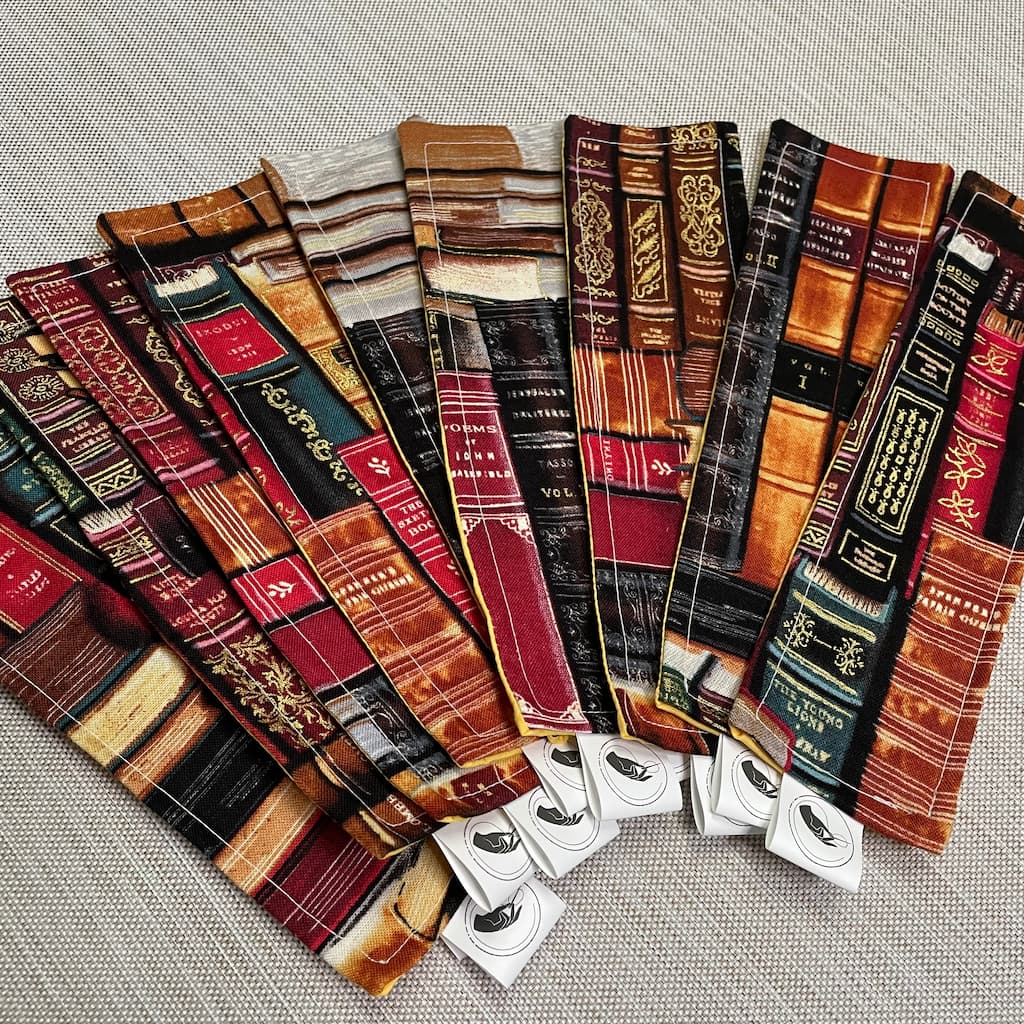 An assortment of fabric bookmarks in a vintage book-themed material made exclusively for us  in collaboration with Belfast-based Remnant Magic